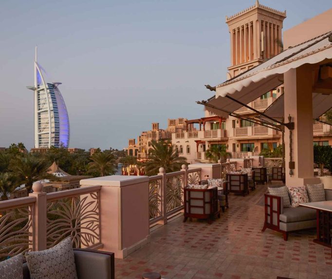 Bar terrace with carved balustrade overlooking Madinat Jumeirah and the Burj Al Arab