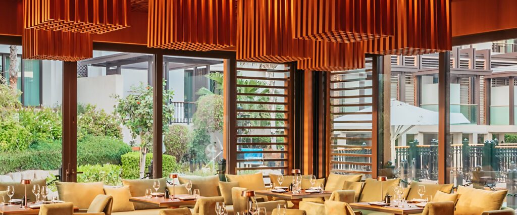 Dining room with timber fins and full height windows onto the garden