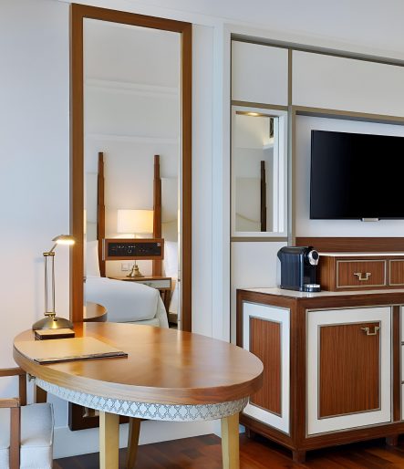 Timber desk and media joinery with inlaid panels in a guest room