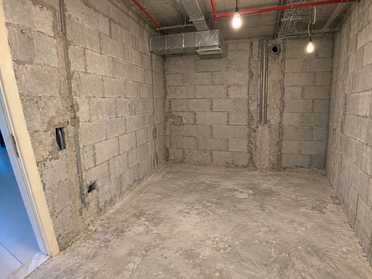 Fitted kitchen with a curved end unit, at shell and core, bare concrete (AI illustration)