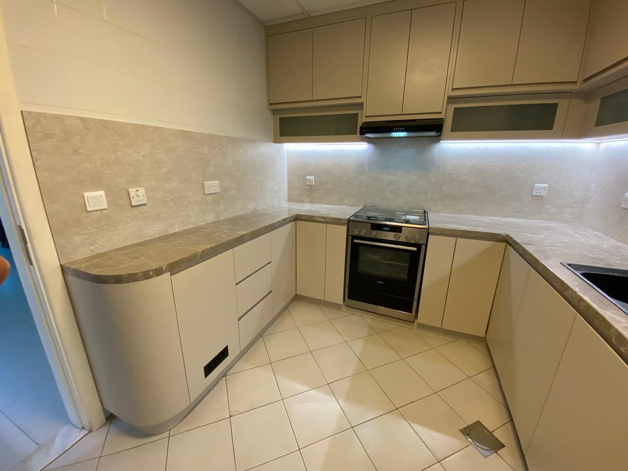 Fitted kitchen with a curved end unit, at handover