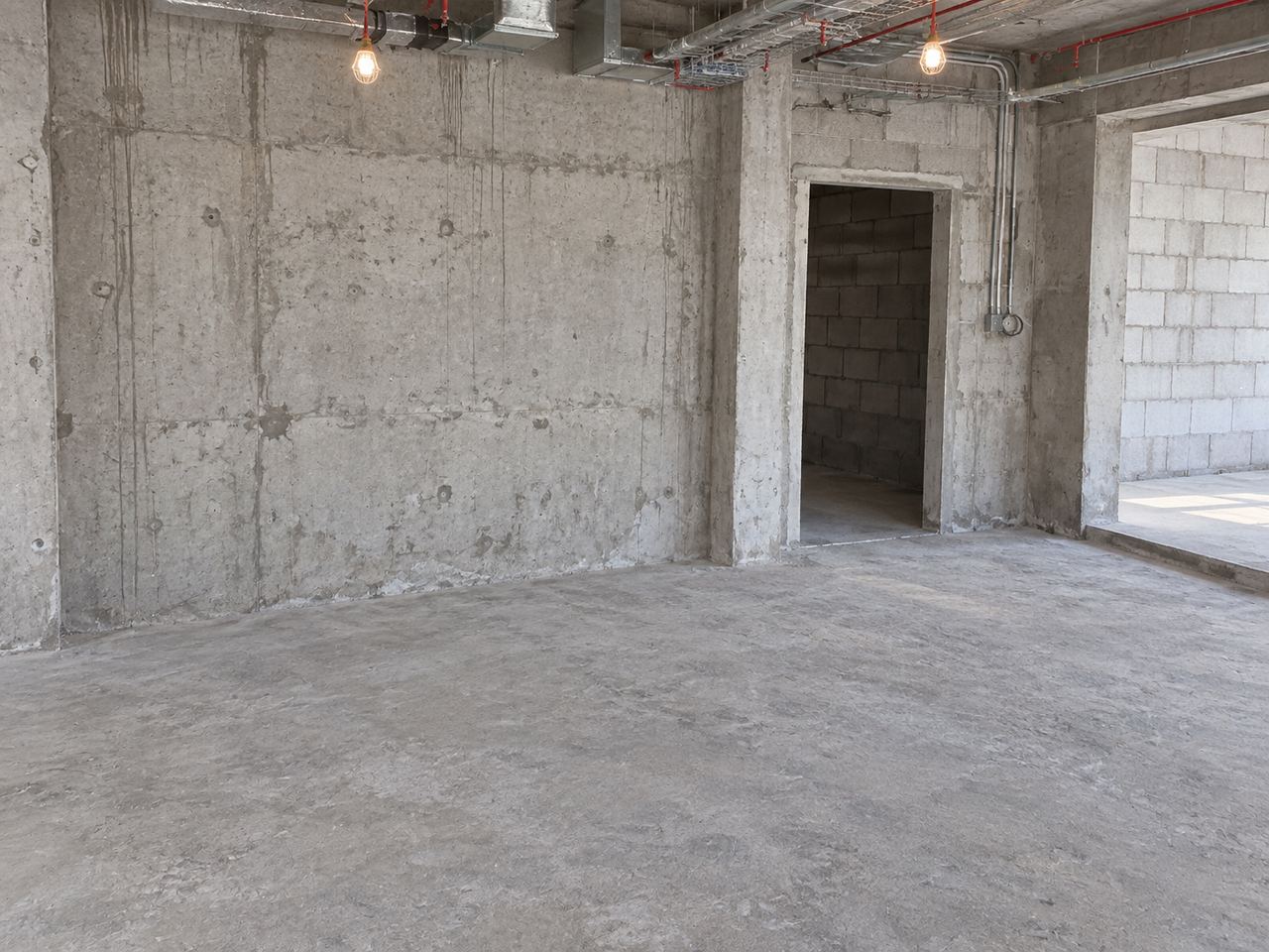 Dressing room with a lacquered island and fitted wardrobes, at shell and core, bare concrete (AI illustration)
