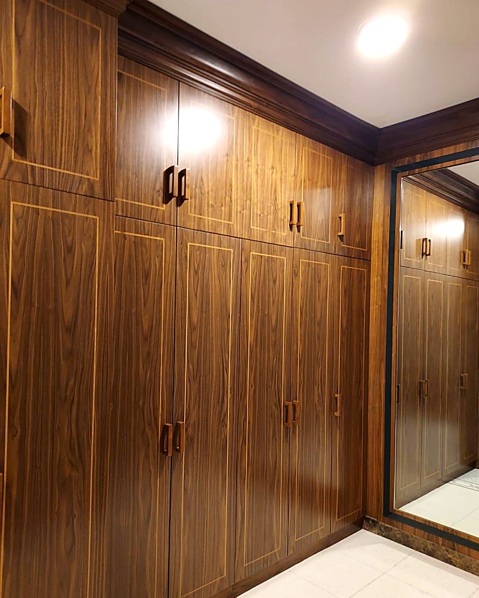 Fitted walnut wardrobes with gold inlay in a private Dubai villa